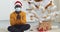 Webcam view young black guy African American man in glasses in yellow sweater and Santa hat sits near Christmas tree at