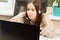 Webinar. Girl in headphones with a microphone in front of a laptop