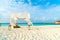 wedding arch on beach with tropical Maldives resort and sea