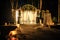 Wedding arch decorated with flower compositions and curtains at night