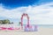 Wedding arch decorated with flowers on tropical beach, outd