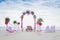 Wedding arch decorated with flowers on tropical beach, outd