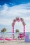 Wedding arch decorated with flowers on tropical beach, outd