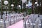 Wedding arch and grey chairs with peonies standing in ceremony a