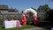 Wedding arch made of red and white balloons, wedding ceremony, green lawn.