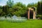 Wedding arch and white chairs in garden