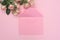 Wedding or birthday mock up scene. Blank open envelope with place for text for spring greeting card. Bouquet of pink