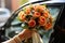 Wedding bliss Bride displays a bright bouquet of orange roses