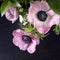 Wedding bouquet of anemones with Ruscus in a jug on a black background