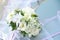 Wedding bouquet on banch. White flowers on blue background