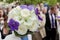Wedding bouquet of the brid in front of guests in blurry background