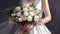 wedding bouquet in bride s hands. The bouquet consists of white