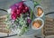 Wedding bouquet with dessert lying on wooden table in bride room