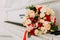 Wedding bouquet of flowers on a white grand piano