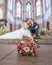 Wedding bouquet on foreground of a blurred kissing couple. Flowers and lovers