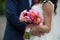 Wedding bouquet of freshly cut flowers closeup with bride and gr