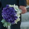 Wedding bouquet in grooms hand