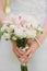 Wedding bouquet of milk and white roses, orchids in the hands of the bride