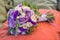 Wedding bouquet on an orange pillow, bouquet of bride from rose cream spray, rose bush, rose purple Memory Lane, violet eustoma, e