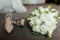 Wedding bouquet from peonies and beige bridal heels. Bridal morning