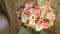 Wedding bouquet of pink roses on the table, laid out a number of