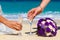 Wedding bouquet and two glasses of champagne on the sand. Male a