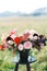 Wedding bouquet in a vase stands on a stool on a green lawn. Close-up