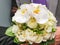 wedding bouquet of white roses, orchids and freesias