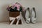 Wedding bouquet in wooden box and bridal wedding heels at the white background. Bridal preparations. Flowers