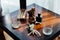 Wedding boutonniere, cigars and alcohol on a wooden table.