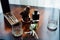 Wedding boutonniere, cigars and alcohol on a wooden table.