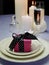 Wedding breakfast dining table setting with pink present gift