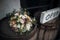 Wedding bridal bouquet, flowers in hands, pink flowers on a wooden background