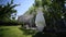 Wedding bridal dress hanging on a tree . garlands and cloth outdoors.