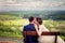 Wedding Bride and groom on a bench with nature landscape scenery background