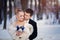 Wedding bride and groom kissing and loving tender couple with bouquet of blue flowers at winter bridal day.