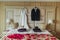 Wedding brides drees and grooms suit hang on the bad with shoes and decorative petals