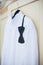 Wedding bright white shirt and black bow. Formal groom shirt with black bow-tie. Elegant white groom\'s shirt close up with bow tie