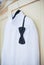 Wedding bright white shirt and black bow. Formal groom shirt with black bow-tie. Elegant white groom\'s shirt close up with bow tie