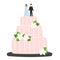 Wedding cake with figurines of bride and groom decorated with flowers