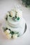 Wedding cake with flowers yellow beige turquoise green