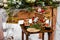 Wedding cake with fruit and an old wooden table with needles of cones and leaves during a wedding ceremony in winter on snow in