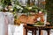 Wedding cake with fruit and an old wooden table with needles of cones and leaves during a wedding ceremony in winter on snow in