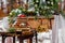 Wedding cake with fruit and an old wooden table with needles of cones and leaves during a wedding ceremony in winter on snow in