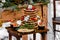 Wedding cake with fruit and an old wooden table with needles of cones and leaves during a wedding ceremony in winter on snow in