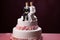 Wedding cake topper with two grooms, figurines of a gay couple. Gay marriage concept. Same-sex gay marriage, wedding sweets and