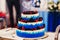 Wedding cake in white blue glaze with fresh berries cherries, blueberries, blackberries, raspberries