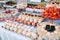 Wedding candy bar with different colored bright cupcakes, macaroons, cakes, jelly and fruits.