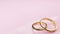 Wedding card Eternity - pink background and two golden rings joined together forever with engraved words