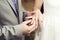 Wedding ceremony. Groom puts on golden wedding ring to bridal`s finger closeup. Bride and groom.